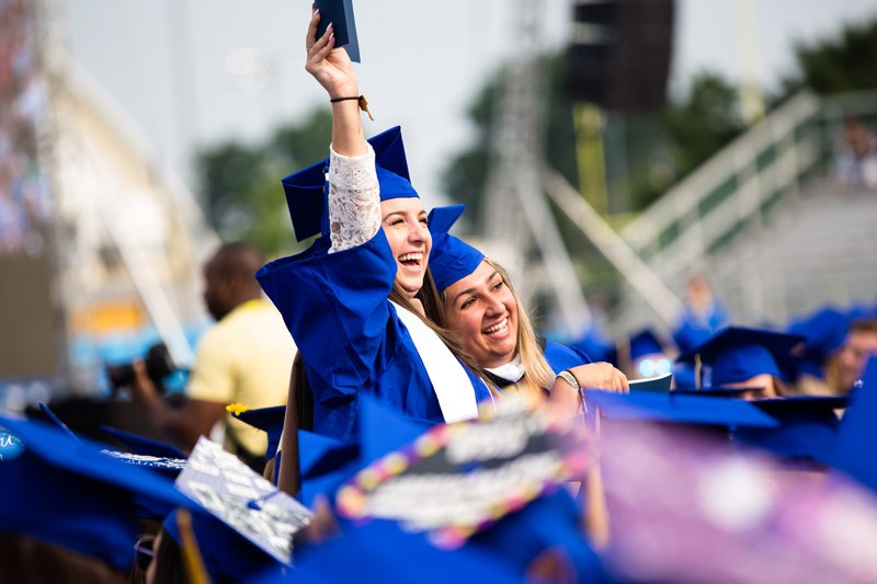 This image shows an aerial view of the decorated graduation caps of undergraduate students in the College of Education and Human Development during the college convocation ceremony.